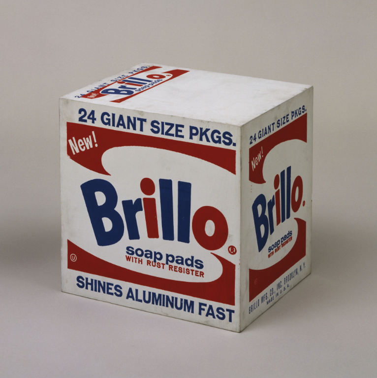 [[#Andy Warhol#]] [[#Άντυ Ουώρχολ#]], Brillo Box (Soap Pads) [Κουτί Brillo (Σφουγγάρια)], 1964, MoMA. Στο έργο αυτό ο Ουώρχολ οικειοποιείται την εικόνα ενός εμπορικού προϊόντος, των σφουγγαριών Brillo, κατασκευάζοντας μεγάλα γλυπτά εφάμιλλα της συσκευασίας τους. Τη συσκευασία των σφουγγαριών Brillo την είχε σχεδιάσει λίγα χρόνια πριν, το 1961, ο Αμερικανός καλλιτέχνης [[#James Harvey#]] [[#Τζέιμς Χάρβεϋ#]], ο οποίος, αν και τεχνοτροπικά το ζωγραφικό του ιδίωμα συνέχιζε την παράδοση του αφηρημένου εξπρεσιονισμού, επιδιδόταν και στον σχεδιασμό εμπορικών προϊόντων για να βιοποριστεί.&nbsp;
