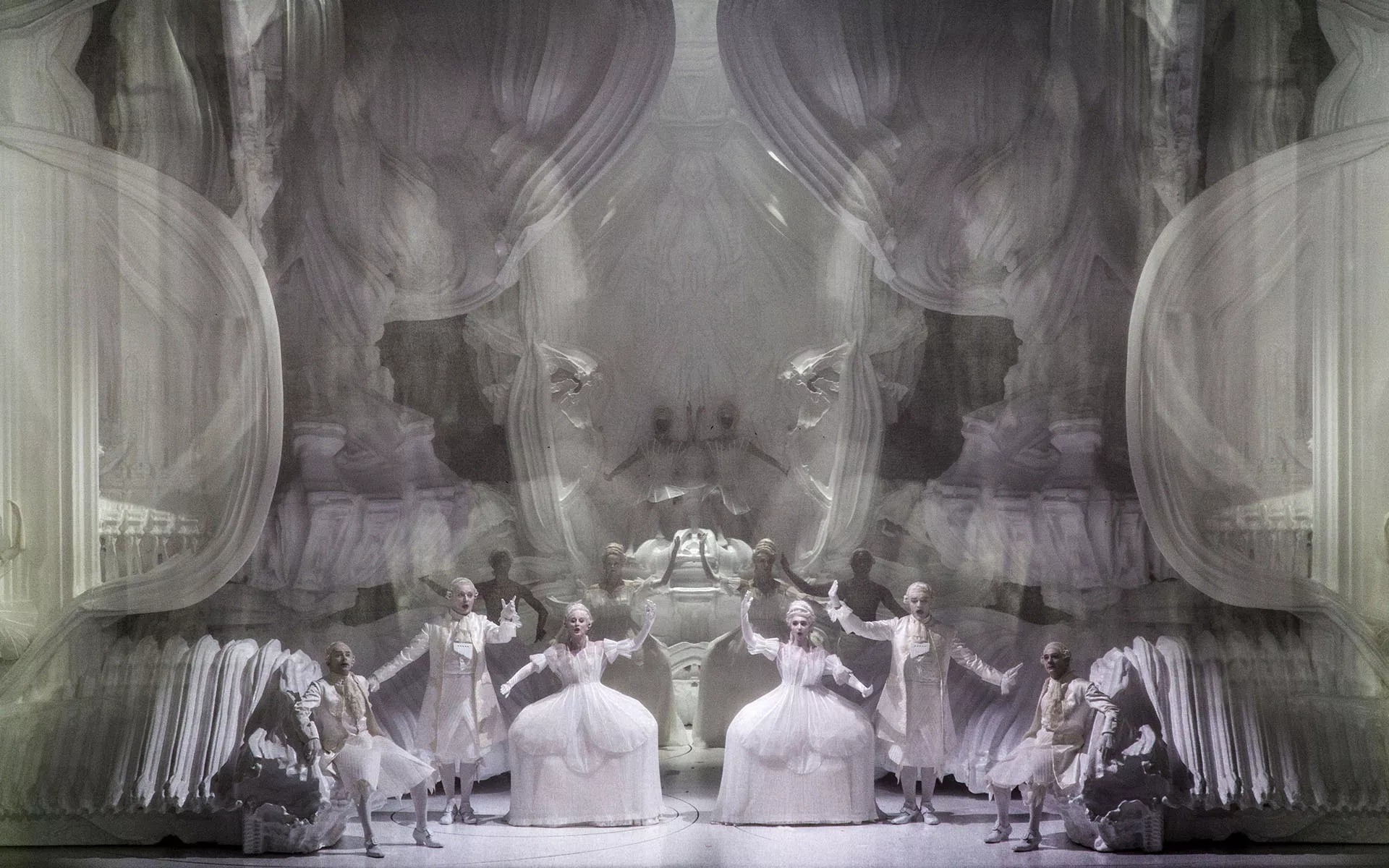 Η σκηνογραφική πρόταση του Michael Hansmeyer [Μίκαελ Χανσμάγιερ] για την παραγωγή της όπερας&nbsp;Ο Μαγικός Αυλός&nbsp;[Die Zauberflöte] σε σκηνοθεσία Romeo Castellucci [Ρομέο Καστελλούτσι] που παρουσιάστηκε στην Όπερα La Monnaie των Βρυξελλών (2018), αποτελεί ένα επαναστατικό δείγμα εφαρμογής της υπολογιστικής αρχιτεκτονικής [computational architecture] στις παραστατικές τέχνες. Ο δημιουργός αξιοποίησε αλγοριθμικές διαδικασίες για τη γέννηση οργανικών και εξαιρετικά σύνθετων μορφών, οι οποίες υπερβαίνουν τις δυνατότητες του παραδοσιακού σχεδιασμού. Οι μνημειώδεις κατασκευές υλοποιήθηκαν μέσω τρισδιάστατης εκτύπωσης μεγάλης κλίμακας [additive manufacturing], επιτρέποντας την ακριβή απόδοση εκατομμυρίων λεπτομερειών που προσδίδουν στον χώρο μια απόκοσμη και ταυτόχρονα κλασικίζουσα αίσθηση. Η συγκεκριμένη χρήση της ψηφιακής τεχνολογίας μετασχηματίζει τη σκηνή σε ένα δυναμικό περιβάλλον όπου η μαθηματική ακρίβεια συναντά το οπερατικό φαντασιακό. Το έργο του Hansmeyer τεκμηριώνει τη μετάβαση της σκηνογραφίας προς τη διευρυμένη ψηφιακή υλικότητα, αναδεικνύοντας πώς ο υπολογιστικός σχεδιασμός μπορεί να προσφέρει νέα αισθητική ταυτότητα στην κλασική δραματουργία.